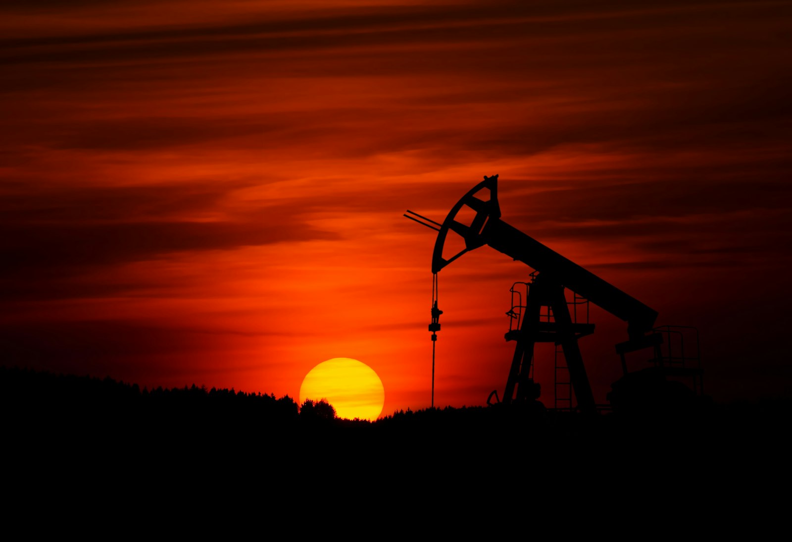 Onshore oil pumpjack at sunset